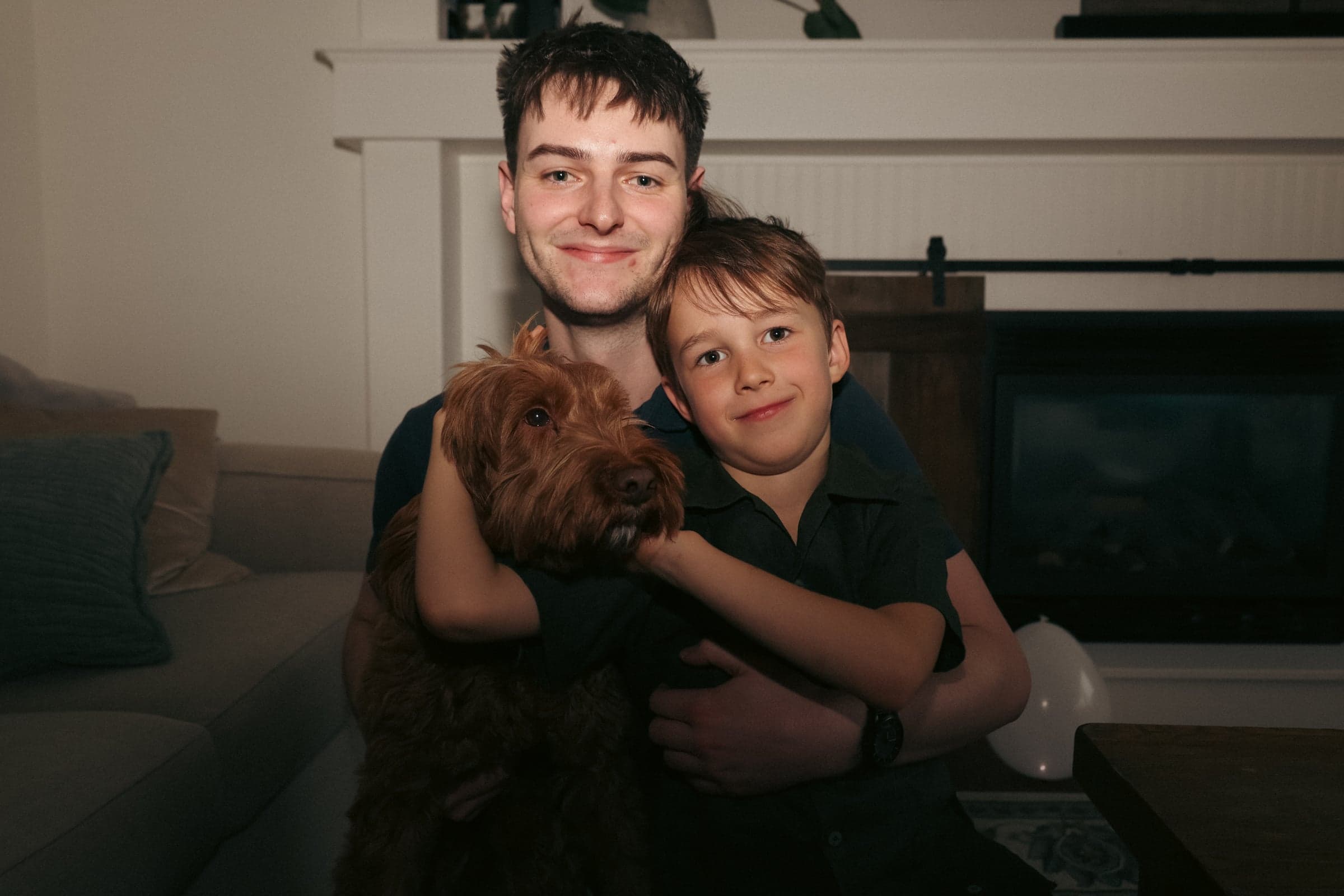 Ethan Johannes at home with his youngest brother and the dog