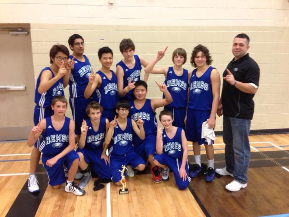 Ethan with his grade 8 basketball team and their trophy