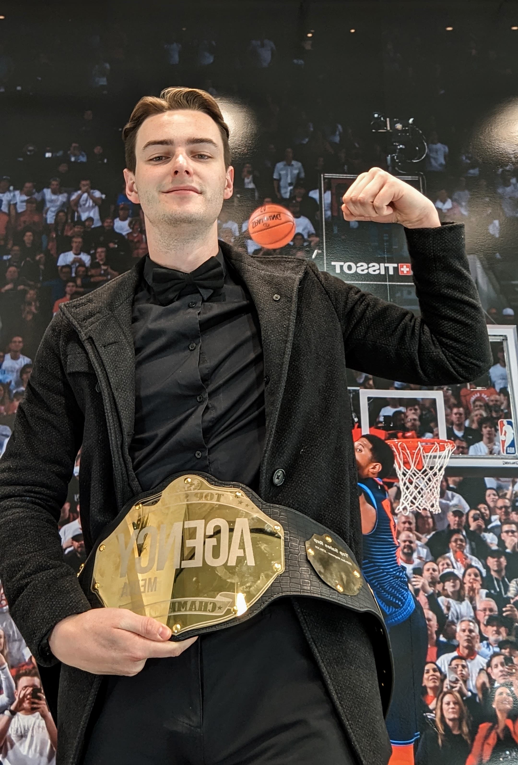 Ethan holding the Agency Media top sales rep championship belt