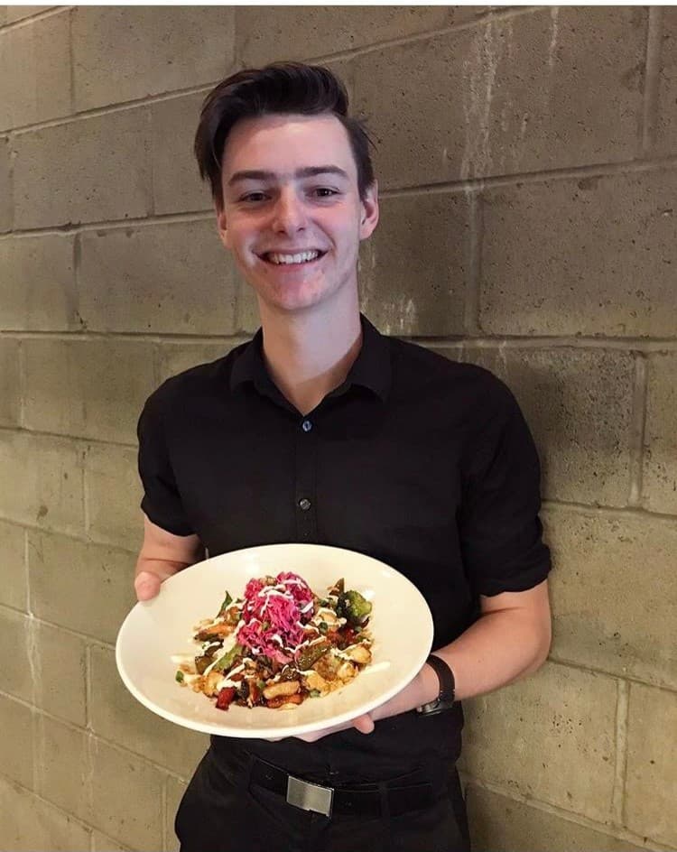Ethan holding a plate at Browns Social House