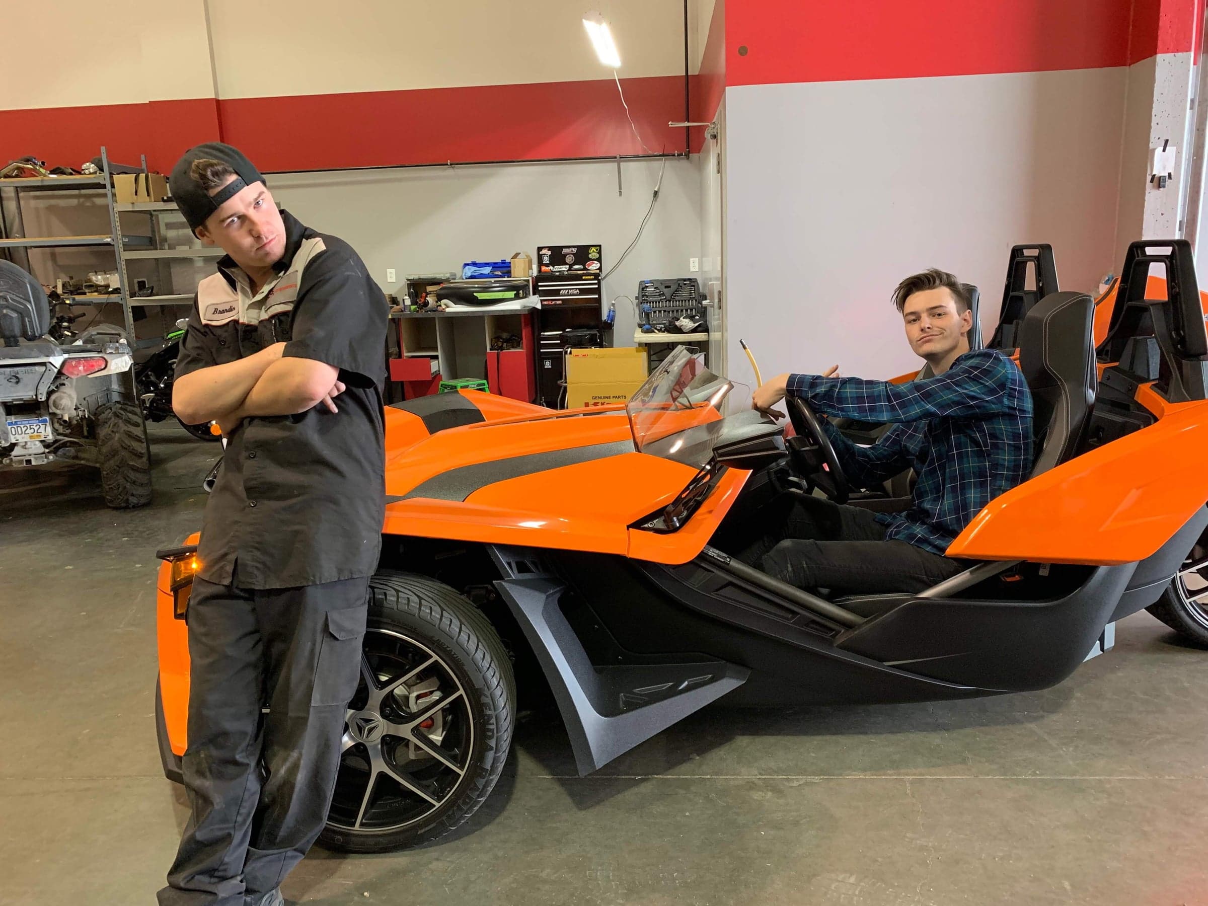Ethan in a Polaris Slingshot on the Sea to Sky shop floor