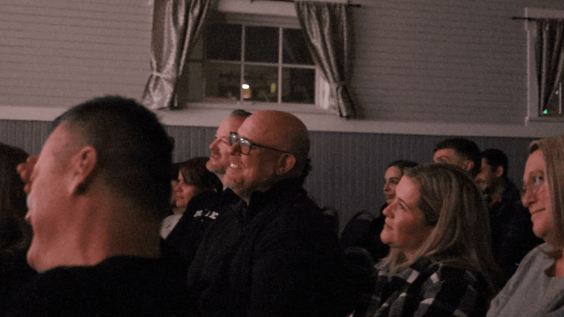 More of the audience mid laugh