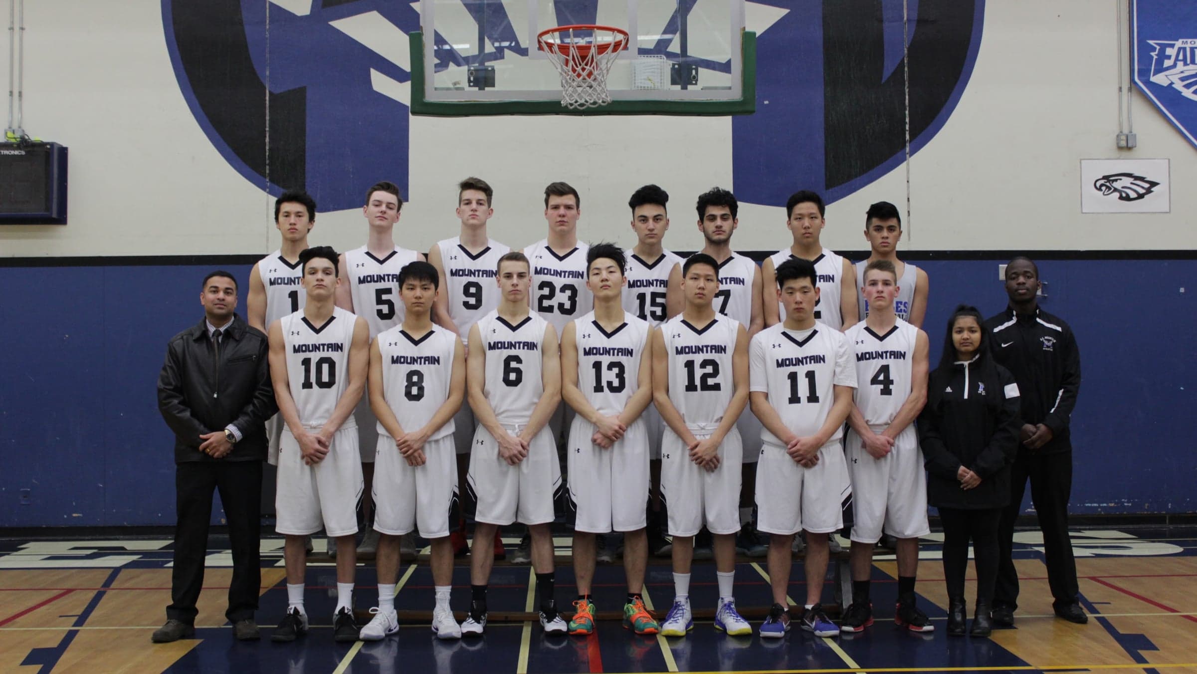 The R.E. Mountain senior boys basketball team in their white home uniforms